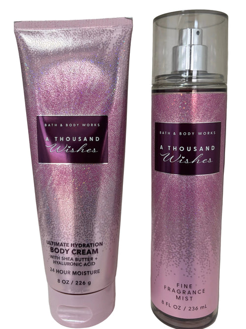 Bath & Body Works 'A Thousand Wishes' body care set featuring a 6 oz tube of Ultimate Hydration Body Cream and a 6 oz spray bottle of Fine Fragrance Mist, both in a shimmering pink and purple holographic finish.